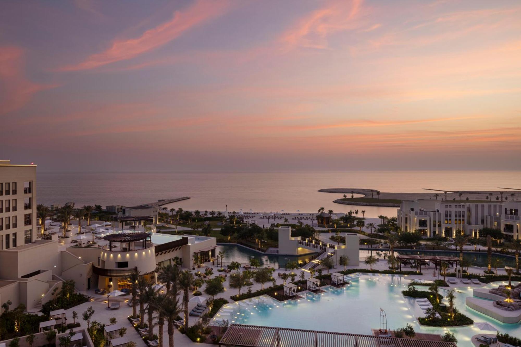 Jumeirah Gulf Of Bahrain Manama Exterior photo The resort at sunset